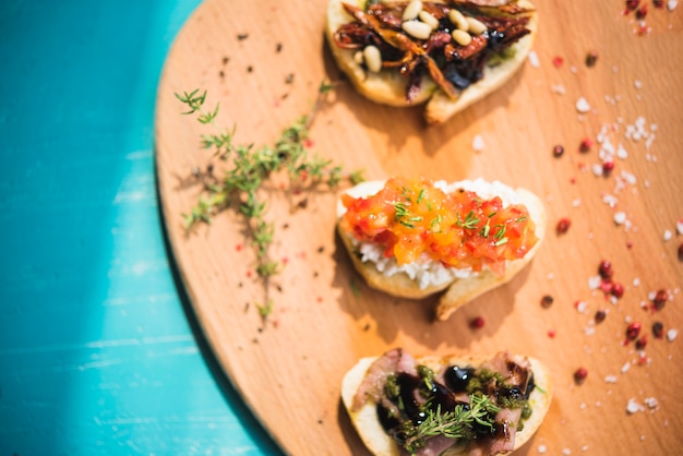 Free Photo toasted sandwiches with thyme; peppercorn and salt on wooden board