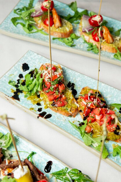 Toasts with tomatoes arugula and grated cheese