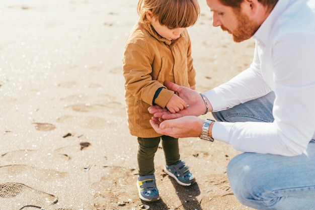 Free photo toddler in coat playing with dad