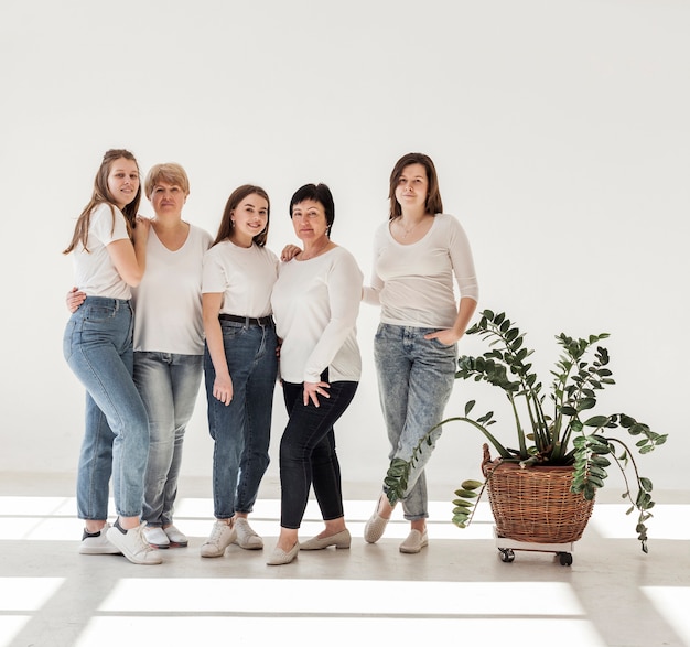 Free photo togetherness group of women standing and plant