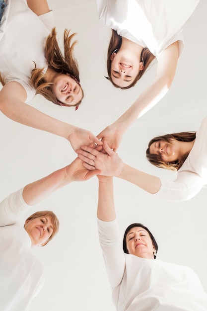 Free photo togetherness group of women touching hands