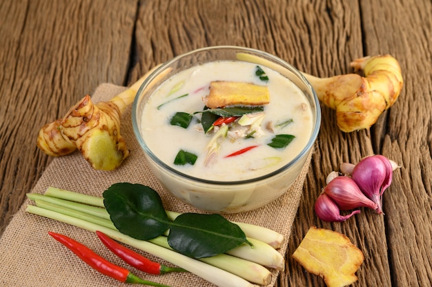 Free Photo tom kha kai in a bowl with kaffir lime leaves, lemongrass, red onion, galangal and chilli.