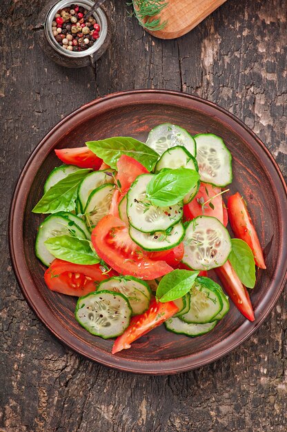 Tomato and cucumber salad with black pepper and basil