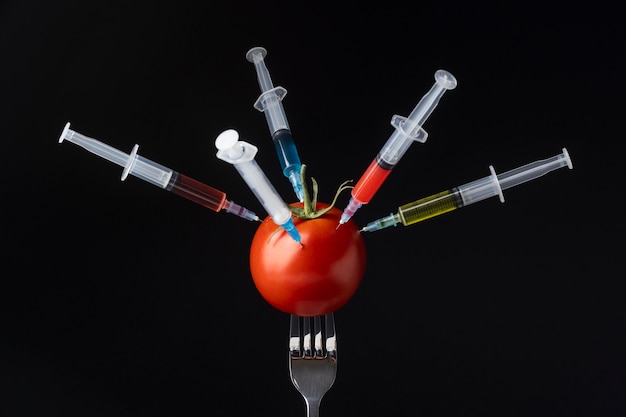 Free Photo tomato filled with syringes