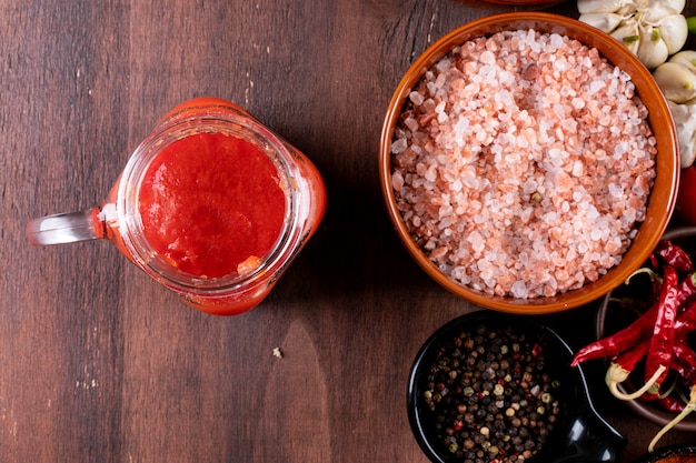 tomato juice with spices top view on wooden table