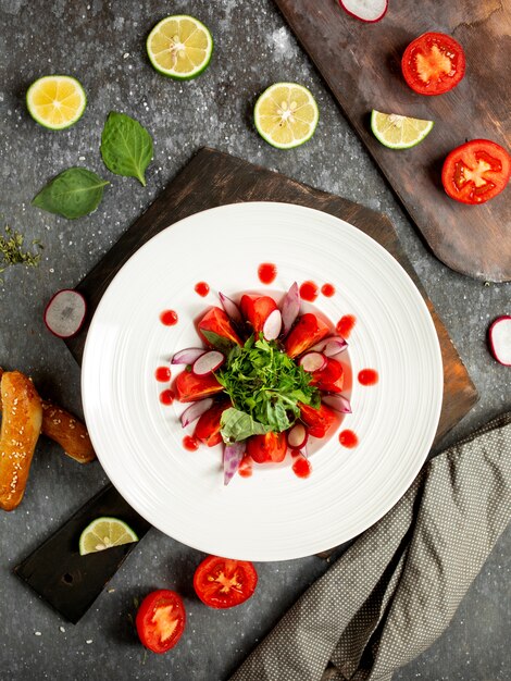 Tomato salad, radishes poured with sauce