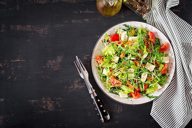 Tomato salad with mix micro greens and camembert cheese.