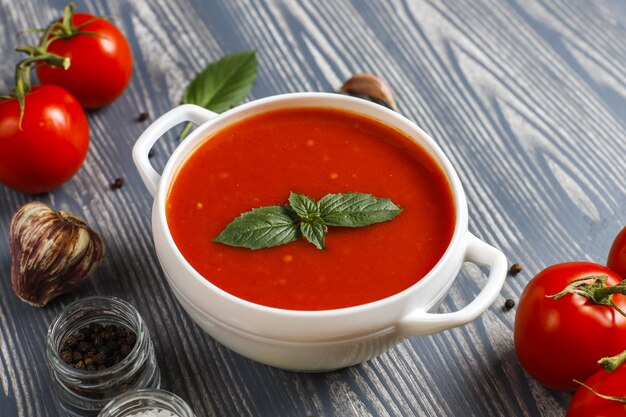 Tomato soup with basil in a bowl.