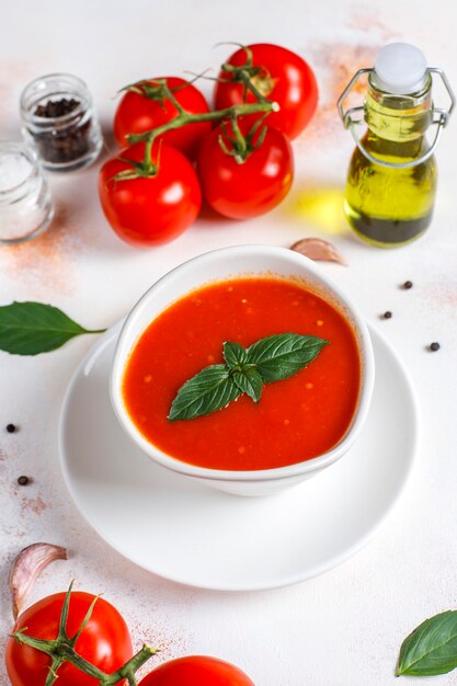 Tomato soup with basil in a bowl.