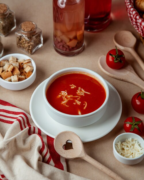 Tomato soup  with cheese  crackers  side view