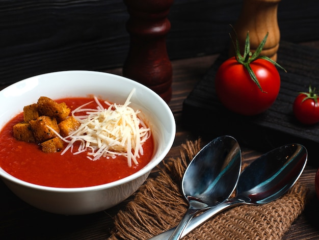 Tomato soup with grated cheese and breadcrumbs