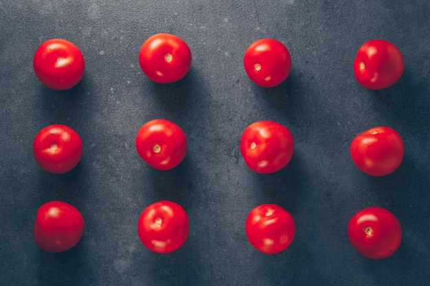 Free photo tomatoes on a gray textured background. top view.