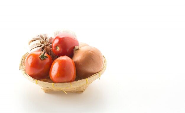 tomatoes, onion and garlic in basket