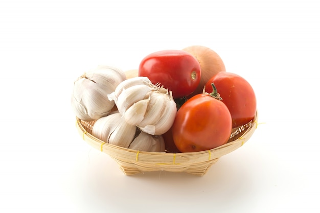 tomatoes, onion and garlic in basket