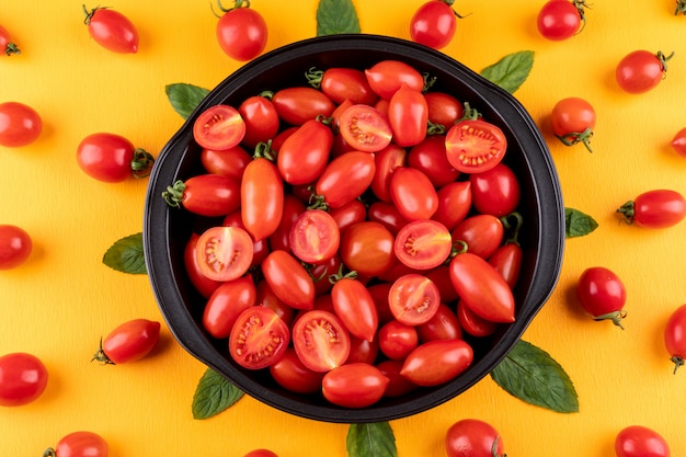 tomatoes in pan on yellow