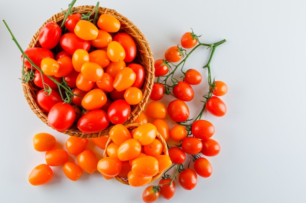 Tomatoes in a wicker basket. flat lay.