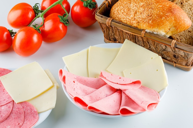 Tomatoes with bread, cheese, sausage high angle view