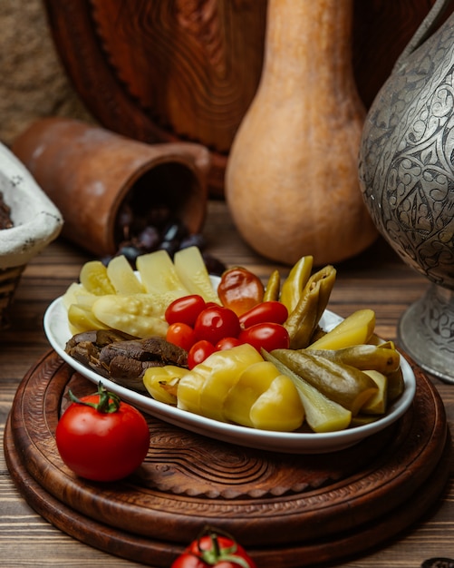 Tomatos and pickles in a plate