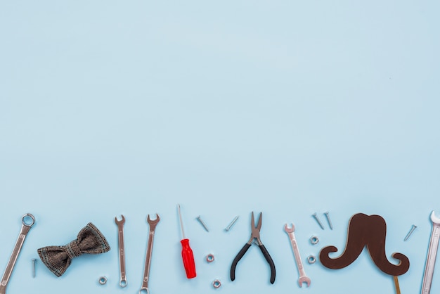 Tools with bow tie and paper mustache