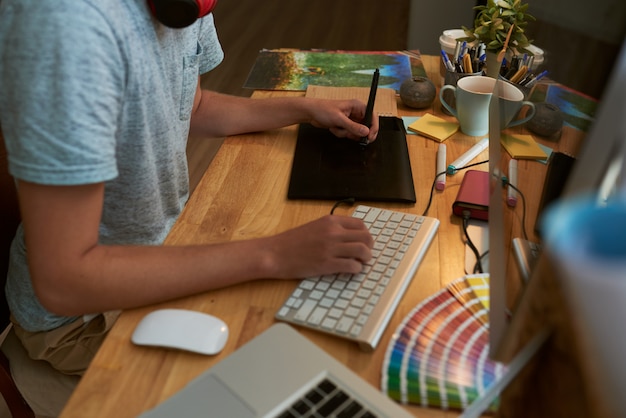 Top angle view of male web designer at work