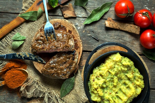 top  beef steak with peppercorn sauce on wooden board