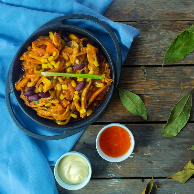 Free Photo top  chicken stew with vegetables and corns in pan served with sweet chili sauce