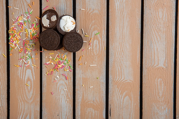 Free Photo top  chocolate cookies and colorful sprinkles scattered