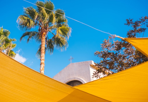 Free Photo the top of the church through yellow street decorations