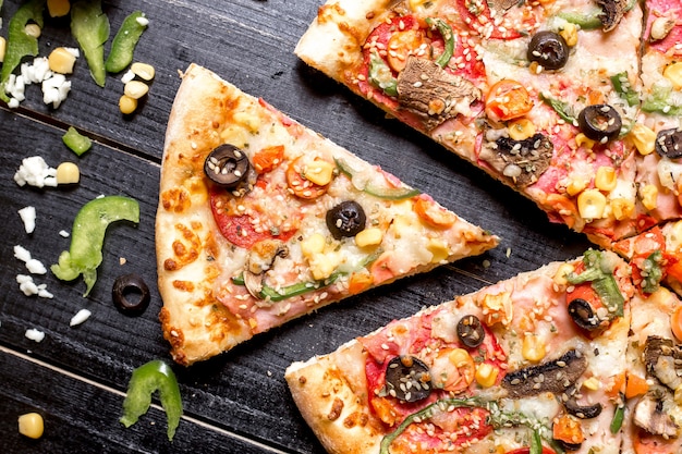 Top close up of pepperoni pizza slice with sesame sprinkles