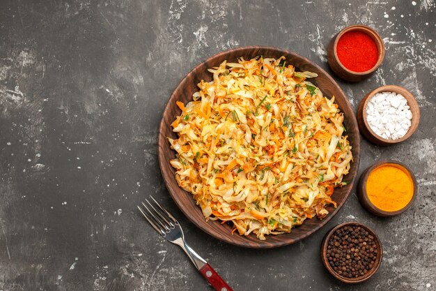 Top close-up view cabbage the appetizing cabbage bowls of colorful spices fork