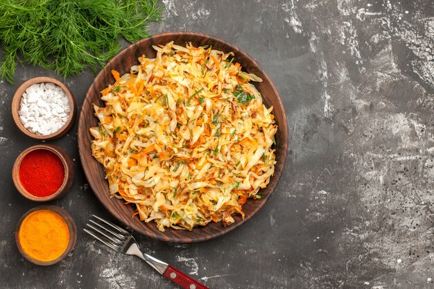 Top close-up view cabbage herbs plate of cabbage fork bowls of spices