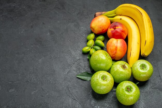 Top close-up view fruits on the table the appetizing nectarines apples bananas citrus fruits