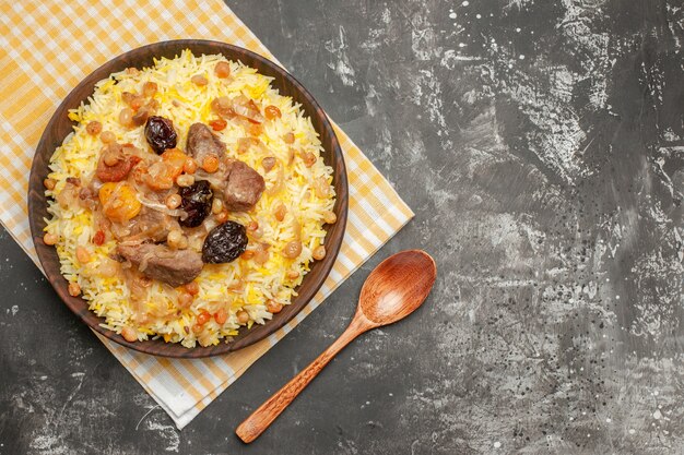 Free Photo top close-up view pilaf an appetizing pilaf on the checkered tablecloth spoon