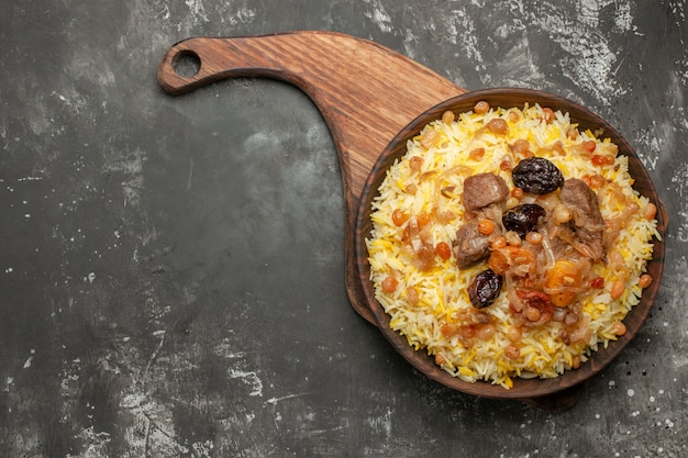 Top close-up view pilaf an appetizing pilaf on the wooden cutting board