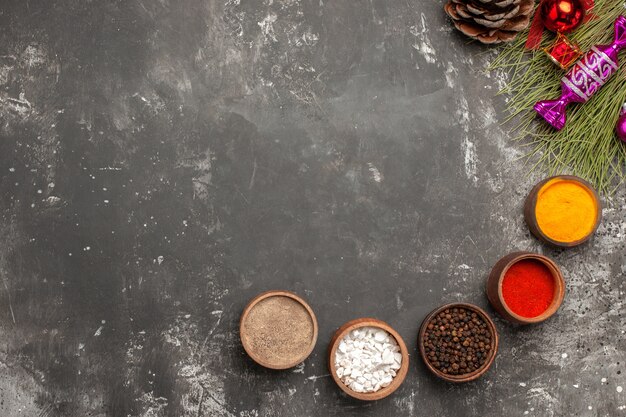 Top close-up view spices bowls of spices Christmas tree toys