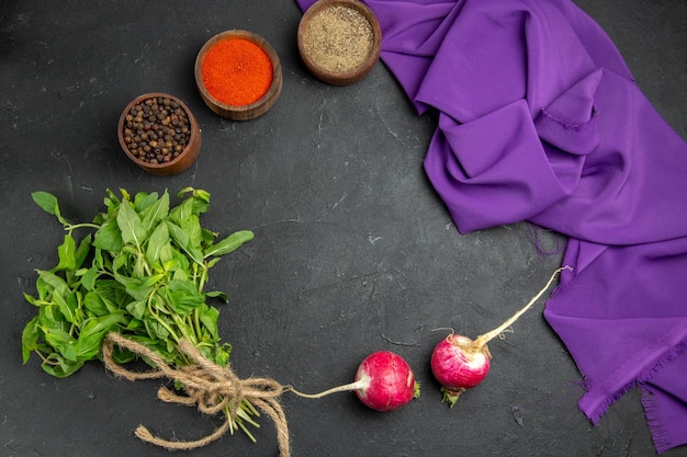 Top close-up view spices raddish herbs colorful spices and the purple tablecloth