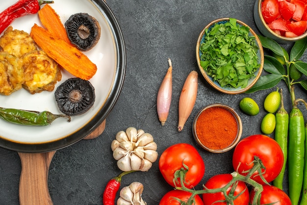 Top close-up view tomatoes the appetizing dish on the board colorful vegetables spices herbs