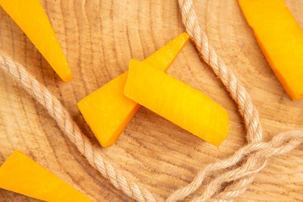 Top close view cheese slices rope on wooden table food photo