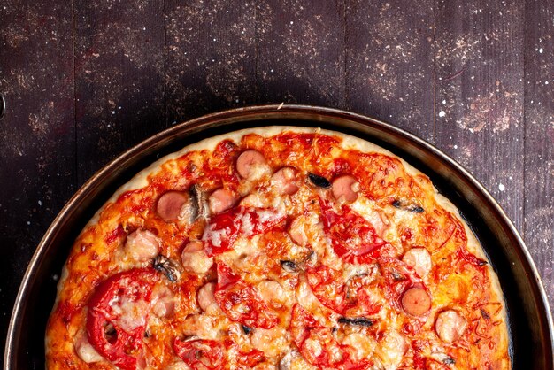 Top close view cheesy tomato pizza with olives and sausages inside pan on brown,  pizza food meal fast food cheese sausage