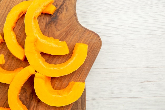 Top close view chopped butternut squash on cutting boards on grey table