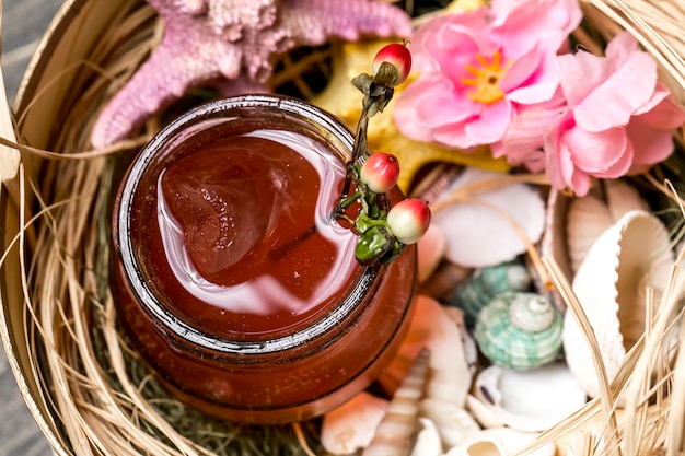 Top close view of cocktail in jar placed in box with seashells and starfish