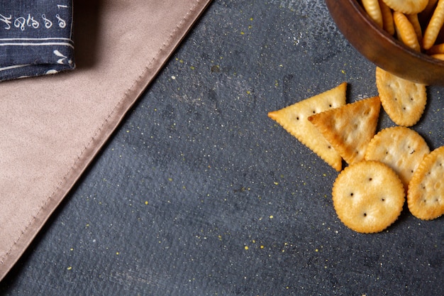 Top close view crackers and crisps on the dark background salt cracker crisp snack