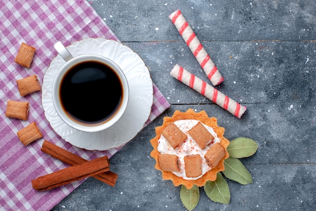 Free Photo top close view of cup of coffee hot and strong along with cakes and cinnamon on grey, coffee candy sweet drink