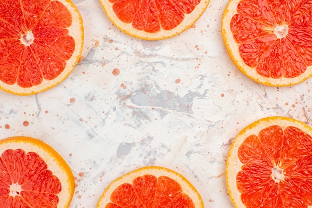 Top close view grapefruits slices on nude background copy space