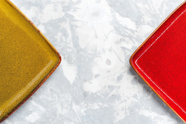 Top closer view empty square plates red and olive colored on white surface plate kitchen food photo cutlery color