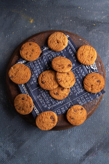 Top distant view delicious chocolate cookies yummy on the dark-grey background cookie biscuit sweet sugar