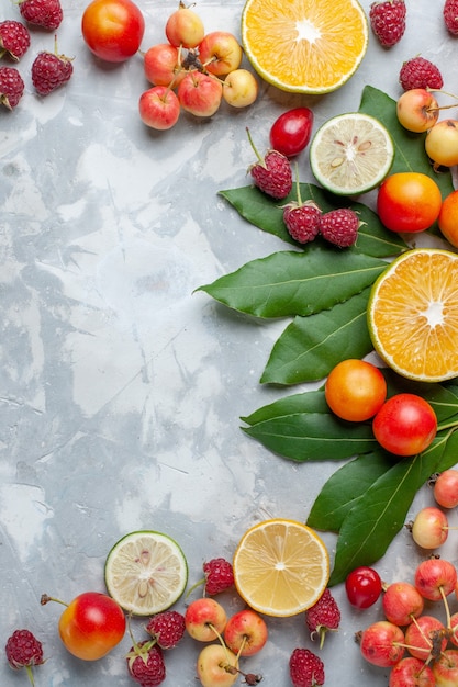 Free photo top distant view lemons and cherries fresh fruits on light-white desk fruit fresh mellow ripe