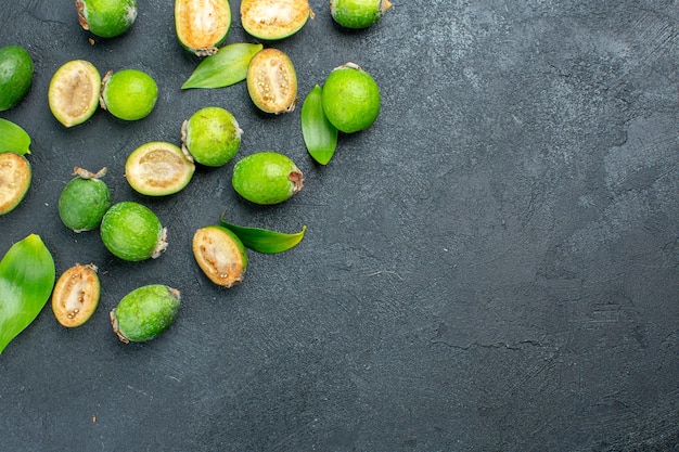 Free photo top half view fresh feijoas on dark surface with copy space