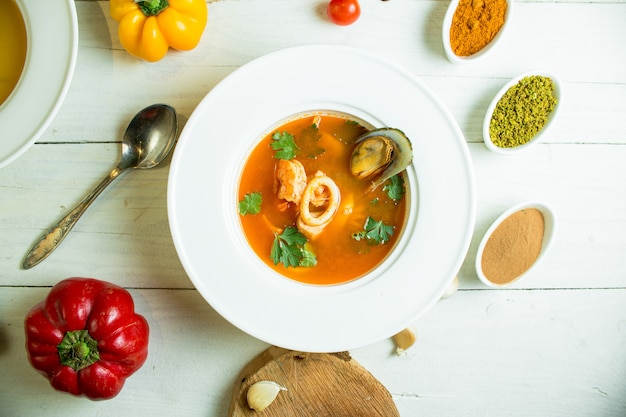 Free Photo top  mussel soup with tomato and herbs in white bowl