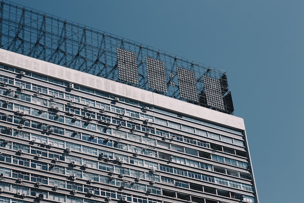 Top of an old apartment building with metal projectiles on the roof and clear blue sky